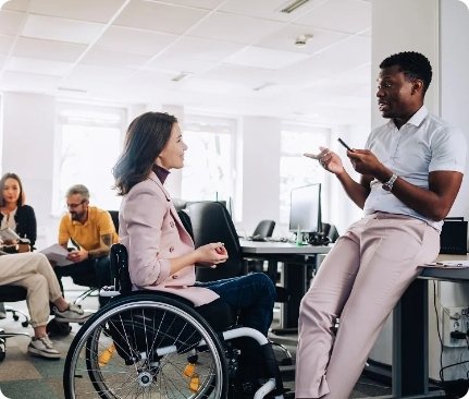 A man and a woman talking. Woman is on a wheelchair
