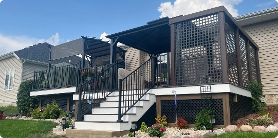 A suburban home featuring a sophisticated white and brown multi-level deck with a gazebo, pergola, and lattice privacy screening.